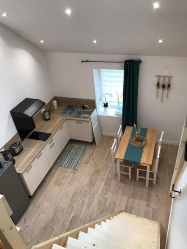 une cuisine et une salle à manger avec une table et une cuisine et une salle à manger dans l'établissement Au Cocon de la Loue, à Charnay