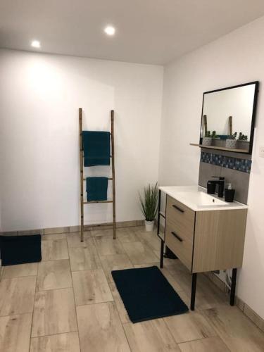 a room with a desk and a mirror on a wall at Au Cocon de la Loue in Charnay