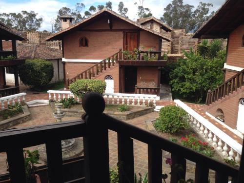 a view of a house from a balcony at Hotel y Hosteria Natabuela in Natabuela