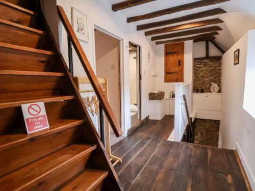 a staircase in a home with wooden floors at The Brewhouse in Church Stretton
