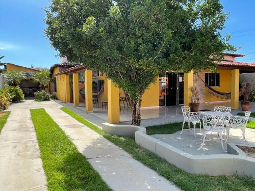 a table and chairs in front of a house at POUSADA CABANA DO PARQUE in Mateiros