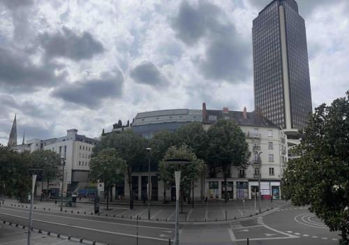 a city with tall buildings and a street with trees at Studio Duquesne 1/2 pers in Nantes