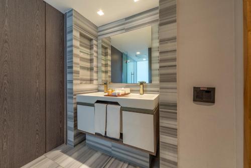 a bathroom with a sink and a mirror at Lifestyle Laghetto Collection in Rio de Janeiro