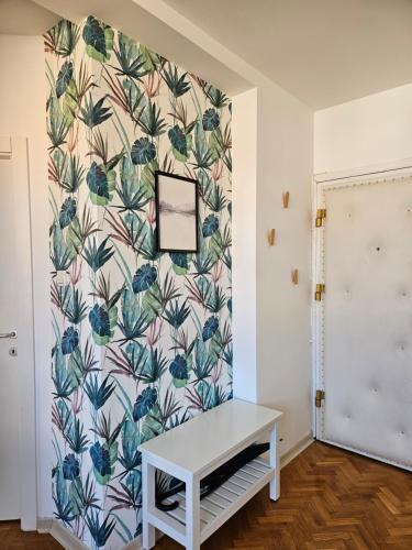 a room with a wall with a floral wallpaper at WELCOME Apartment in Novi Sad