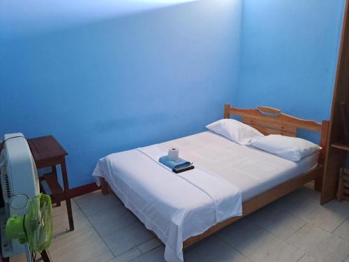 a bedroom with a bed with a candle on it at Residencia Grecia in Leticia