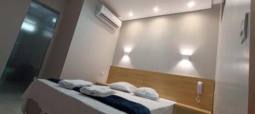 a room with a mirror and towels on a table at Hotel New Space in Sao Paulo