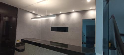 a bathroom with a counter and a mirror and a sink at Hotel New Space in Sao Paulo