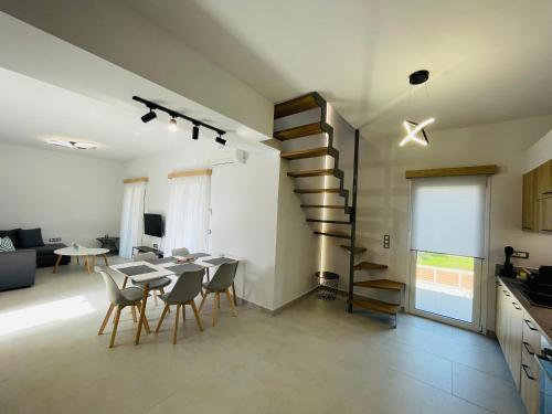 a living room with a table and a spiral staircase at Room in Apartment - Villa Rodelia nr4 in Roda in Roda