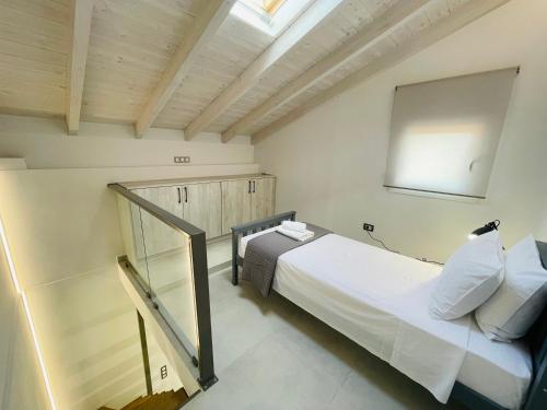 a bedroom with a large white bed and a window at Room in Apartment - Villa Rodelia nr4 in Roda in Roda
