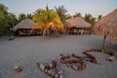 a word written in the sand on a beach at Cabañas Casa de Agua in Boca del cielo