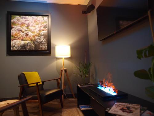 a living room with a lamp and a painting on the wall at M&UGA Hotela in Elorrio