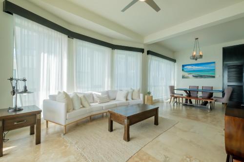 a living room with a white couch and a table at Diamante Beachfront Suites in San Pedro