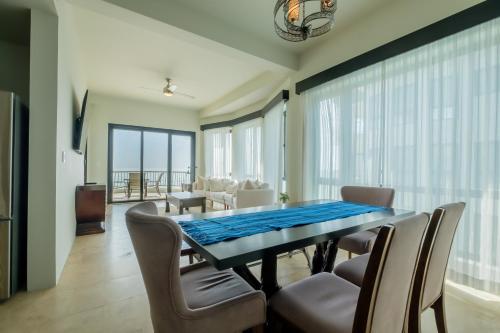 a dining room with a table and chairs at Diamante Beachfront Suites in San Pedro