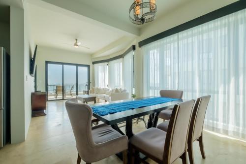 a dining room with a table and chairs at Diamante Beachfront Suites in San Pedro