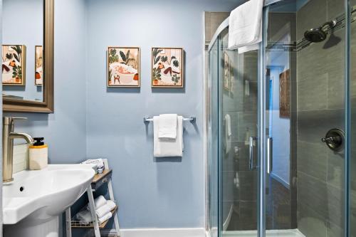 a bathroom with a shower and a sink at Olivia Oasis in Oxnard