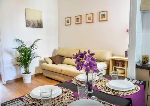 a living room with a table and a couch at bcn4days 24/7 Apartments in Hospitalet de Llobregat