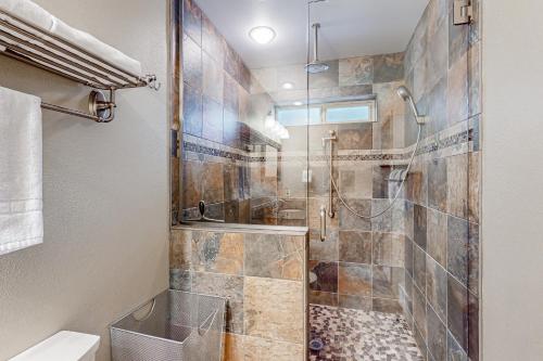 a bathroom with a walk in shower and a toilet at Fairway View in McCall