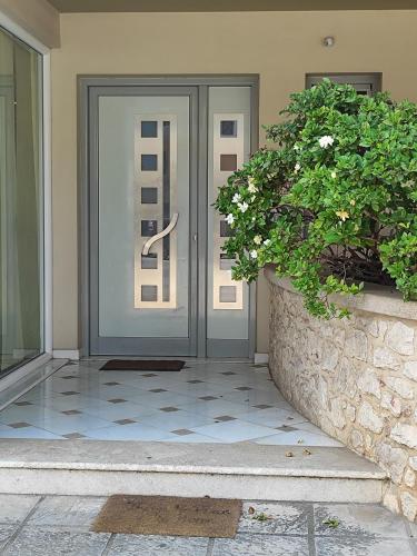 a front door of a home with two potted plants at Δροσια 1 in Nafplio