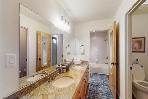 a bathroom with two sinks and a toilet at Eagle's Perch in Shaver Lake