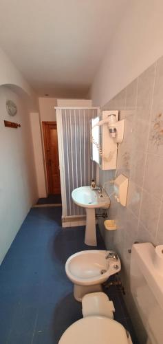 a bathroom with a white toilet and a sink at Casa Vittorio B&b in Lipari