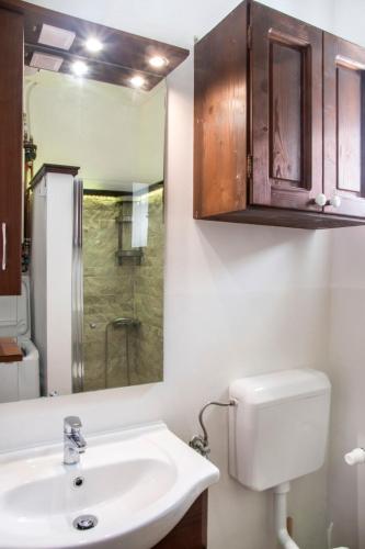 a bathroom with a sink and a toilet and a mirror at SáBa Vendégház in Tapolca