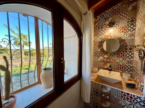 a bathroom with a window and a sink and a mirror at Hotel Altea Paradise 1917 - Adults Only in Altea