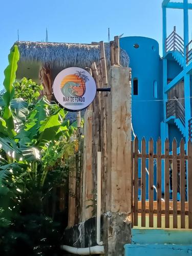 a sign on the side of a blue building at Mar de Fondo in Puerto Escondido