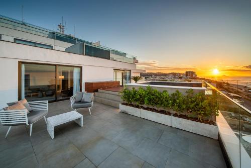 a rooftop patio with a view of the ocean at Lifestyle Laghetto Collection in Rio de Janeiro