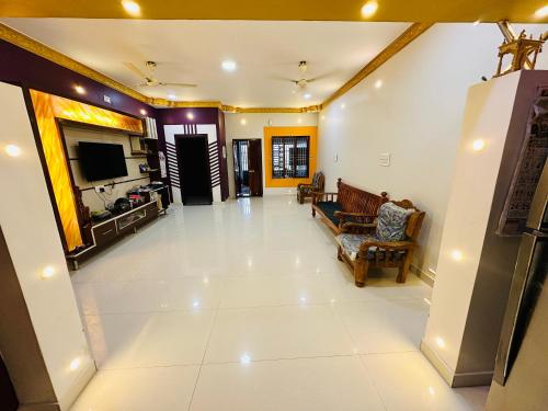 a large living room with a television and a couch at SS Home Stay Accomodation in Tiruvannāmalai