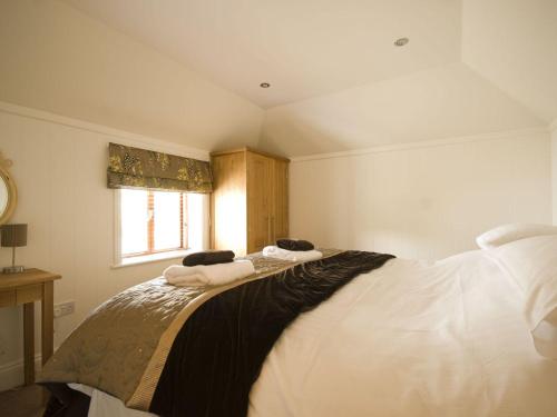 a bedroom with a bed with towels on it at Lavender Barn in Newquay
