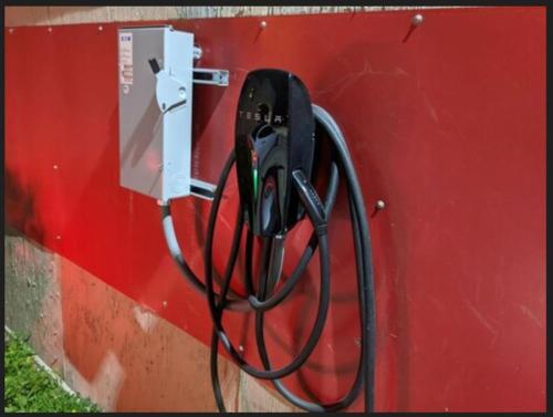 a pay phone is hooked up to a red wall at Atrium Inn in Fort Stockton