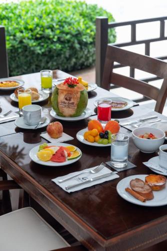 a wooden table with plates of food on it at Vila Galé Fortaleza in Fortaleza