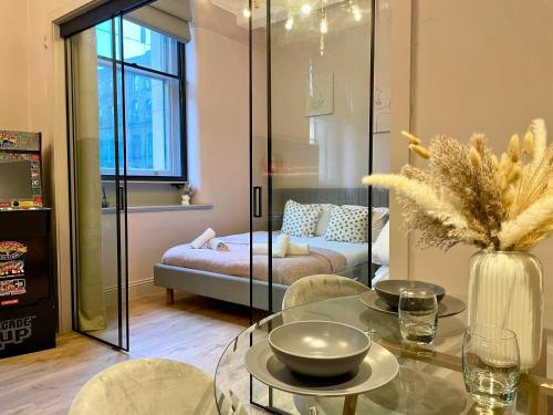 a living room with a glass table and a couch at Stunning Apartment in Manchester City Centre in Manchester