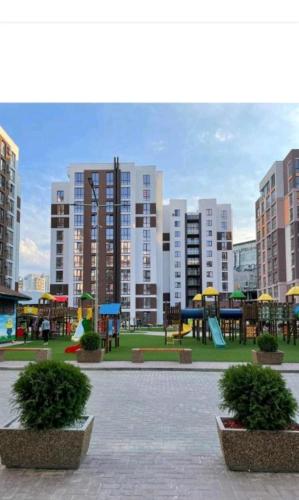 a playground in a city with tall buildings at AIRPORT 24&24 CAR PARKING in Chişinău