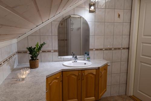 a bathroom with a sink and a mirror at Panoramic Penthouse in Trondalen