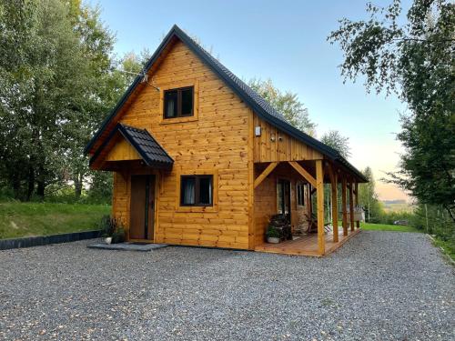 a large wooden house with a gambrel roof at Zamojskie Bieszczady in Stary Zamość