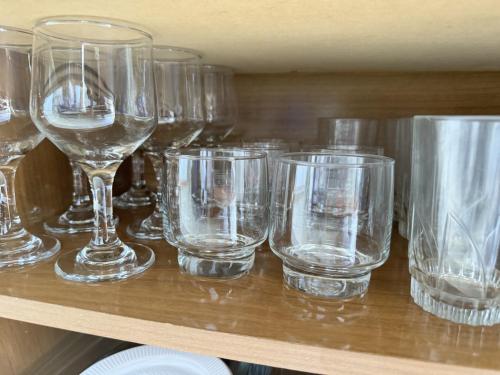 a bunch of wine glasses sitting on a shelf at Refugio em Salvador com vista para o mar - Salvador in Salvador