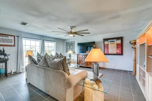 a living room with a couch and a ceiling fan at Canal-Front Ruskin Home with Private Hot Tub and Dock! in Ruskin