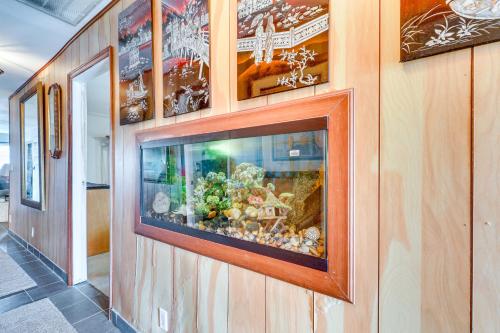 a fish tank on a wall in a room at Canal-Front Ruskin Home with Private Hot Tub and Dock! in Ruskin