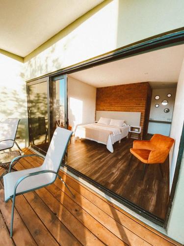 a view of a bedroom from a balcony with a bed at Palta 60 Valle de Guadalupe in Valle de Guadalupe
