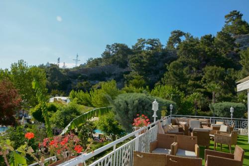 a balcony of a garden with chairs and flowers at MIRAMOR HOTEL & Spa - ULTRA ALL INCLUSIVE SELECTION in Kemer