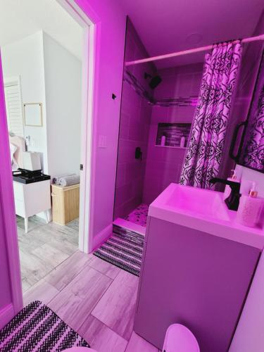 a pink bathroom with a sink and a shower at Modern Dream Rooms Suits - Private, parking, Wi-Fi, Netflix in Spring Hill