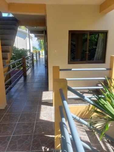 a hallway of a house with a railing at Beach Side Condos Caye Caulker by CCVH in Caye Caulker