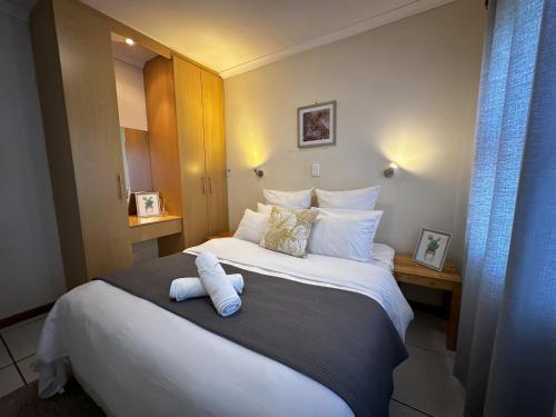 a hotel room with a bed with a teddy bear on it at The Hide on Devereux in East London