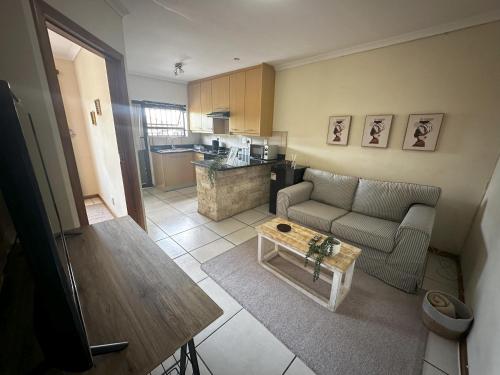 a living room with a couch and a coffee table at The Hide on Devereux in East London