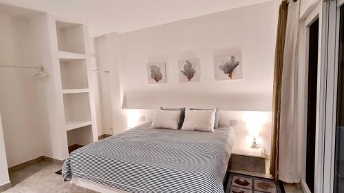 a bedroom with a bed with two pillows on it at Yellow Heron House in Puerto Villamil