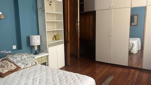 a bedroom with a bed and a closet and a lamp at GABY'S HOME in Buenos Aires