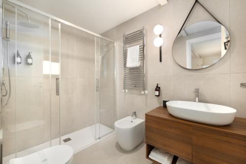 a bathroom with a sink toilet and a mirror at La casetta di Grace in Sesto Fiorentino