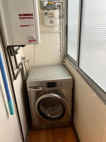 a washing machine in a small room with a window at Cozy apartment for 7 people - Port Aventura in Vila-seca