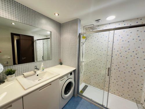 a bathroom with a sink and a washing machine at Beautiful 100m apartment in Palm Mar in Palm-mar
